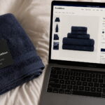 Flatlay of towel next to laptop showing product page